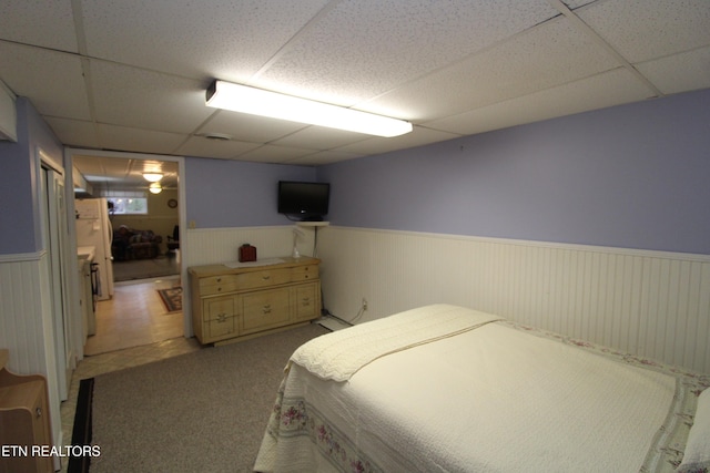 carpeted bedroom with a drop ceiling