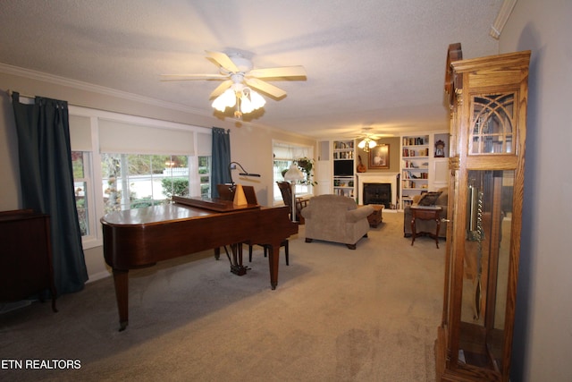 interior space featuring built in shelves, ceiling fan, ornamental molding, a textured ceiling, and carpet floors