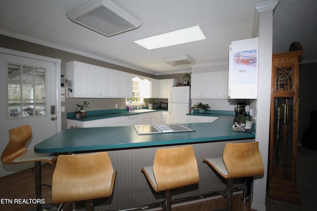 kitchen with ornamental molding, sink, white refrigerator, dark hardwood / wood-style floors, and white cabinetry