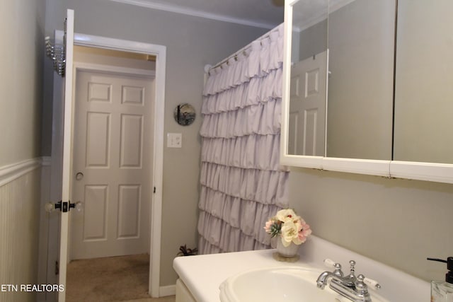 bathroom featuring vanity and ornamental molding