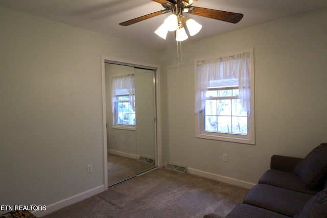 unfurnished room with carpet flooring and ceiling fan