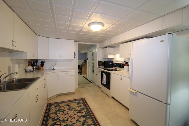 kitchen with white cabinets, white appliances, and sink