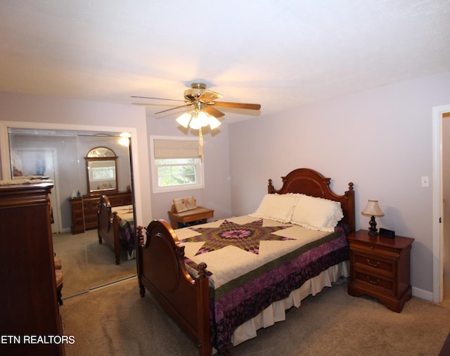 carpeted bedroom with ceiling fan and a closet