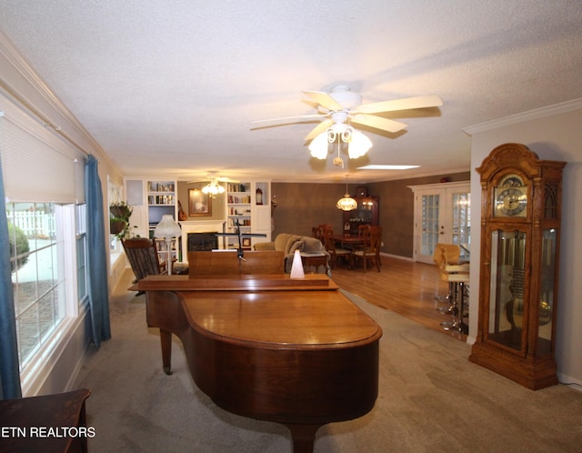 interior space featuring crown molding, french doors, ceiling fan, and a textured ceiling