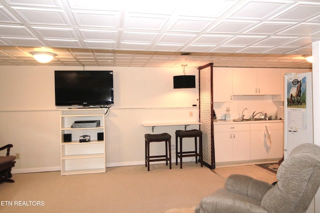 living room featuring light carpet and sink