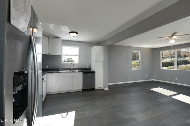 kitchen featuring appliances with stainless steel finishes, white cabinetry, and a healthy amount of sunlight