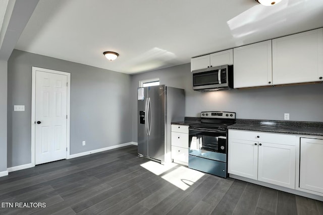 kitchen featuring white cabinets, stainless steel appliances, and dark wood-type flooring