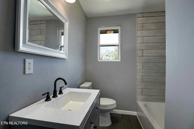 full bathroom featuring hardwood / wood-style floors, vanity, shower with separate bathtub, and toilet