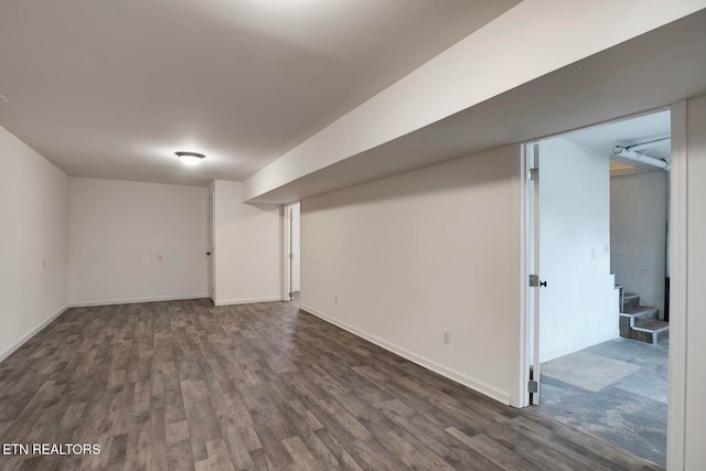 basement with dark hardwood / wood-style flooring