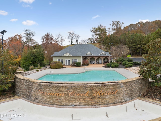 view of pool with french doors