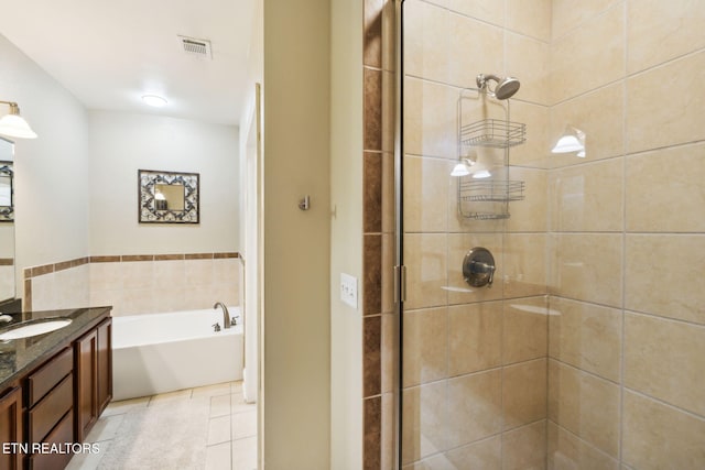 bathroom with tile patterned floors, vanity, and separate shower and tub