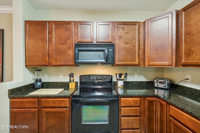 kitchen with dark stone countertops and black appliances