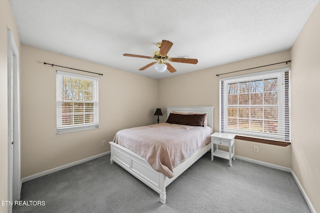 bedroom with carpet flooring, multiple windows, and ceiling fan