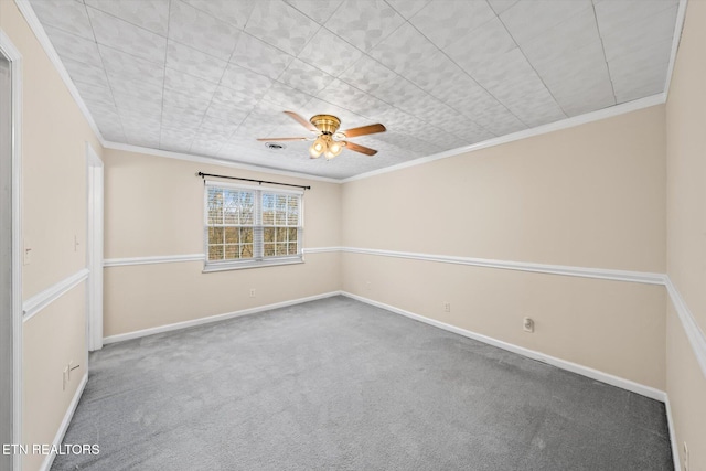 carpeted empty room with ceiling fan and crown molding