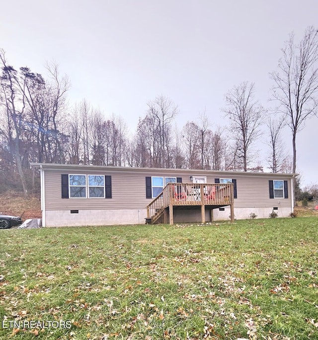 view of front of home with a wooden deck and a front lawn