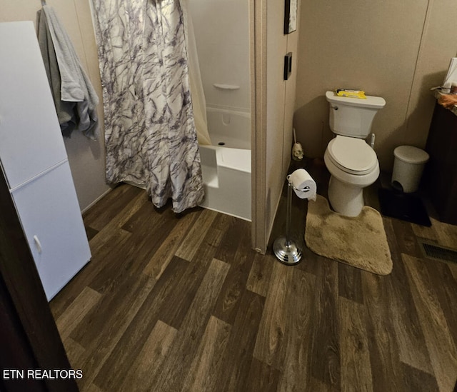 bathroom featuring toilet, shower / bath combo, and hardwood / wood-style flooring