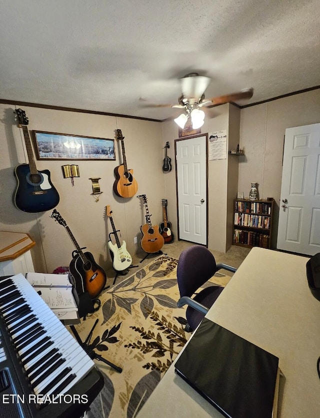 carpeted home office with ceiling fan, a textured ceiling, and ornamental molding