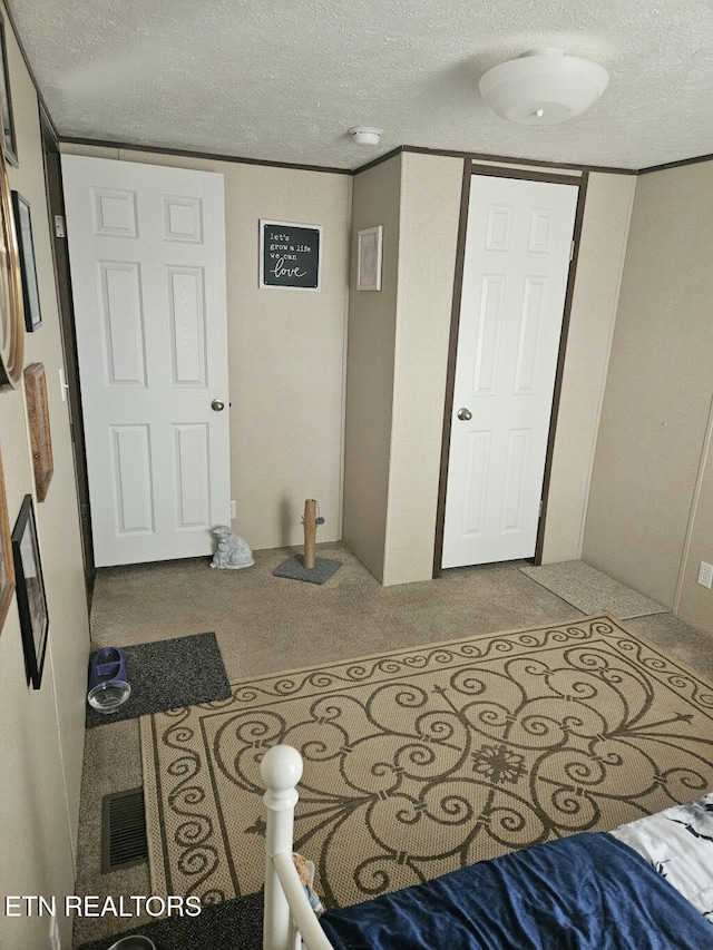 carpeted bedroom with a textured ceiling