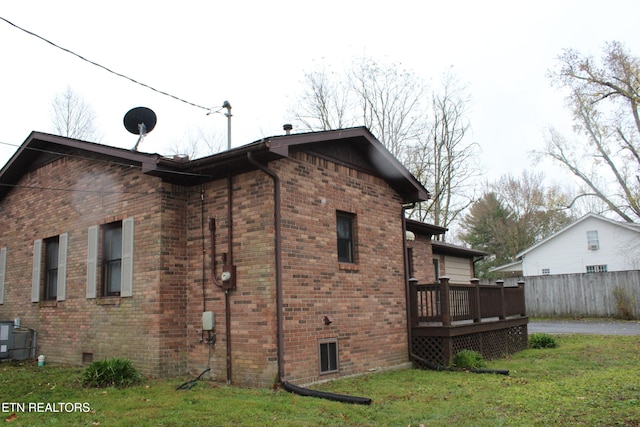 view of property exterior with a yard and a wooden deck