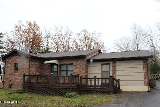 rear view of property featuring a deck