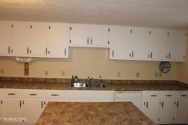 kitchen with sink, white cabinets, white dishwasher, and a textured ceiling