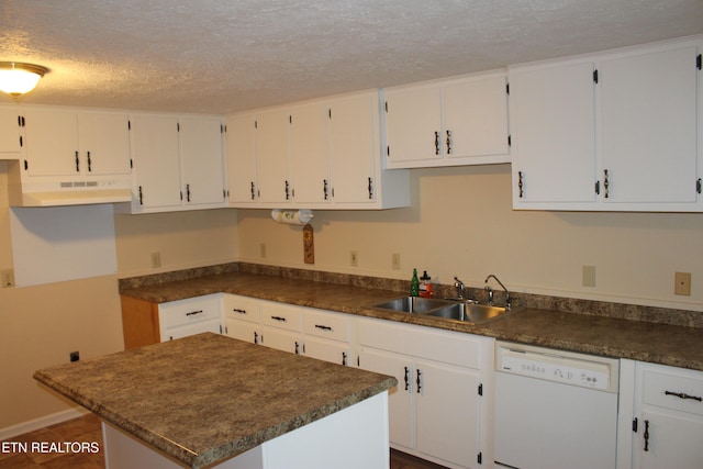 kitchen featuring white cabinetry, white dishwasher, and a textured ceiling