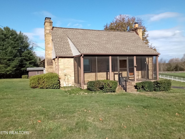 exterior space with a sunroom and a front yard