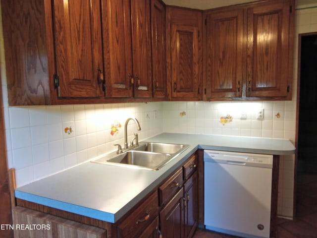 kitchen featuring backsplash, sink, and white dishwasher