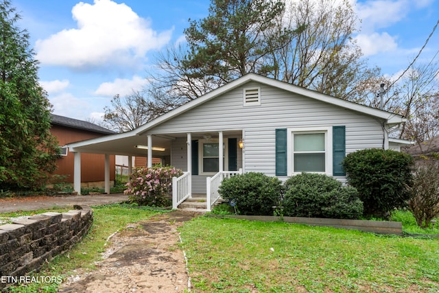 view of front of property with a porch and a front lawn