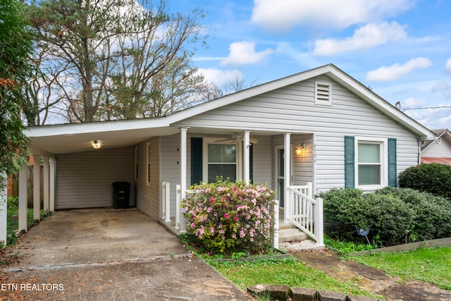 view of front facade with covered porch and a carport