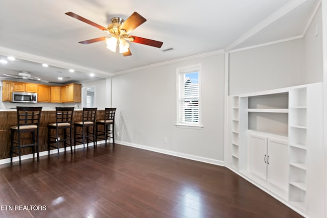 living room featuring crown molding, dark hardwood / wood-style flooring, and ceiling fan