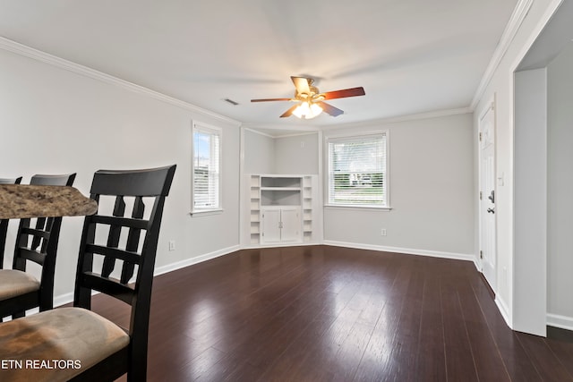 dining area featuring ornamental molding, dark wood-type flooring, and a healthy amount of sunlight