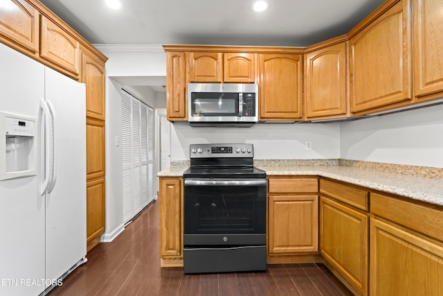 kitchen featuring dark hardwood / wood-style floors, light stone counters, crown molding, and appliances with stainless steel finishes