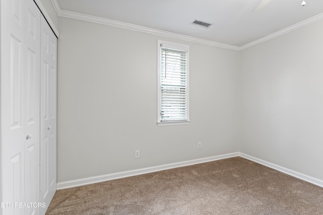 unfurnished bedroom featuring carpet flooring, crown molding, a closet, and ceiling fan