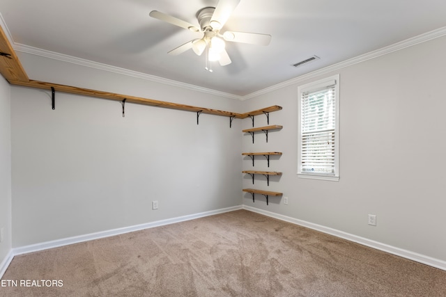 spare room featuring ceiling fan, crown molding, and light carpet