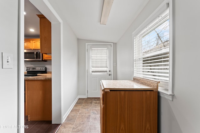 kitchen featuring lofted ceiling and black / electric stove