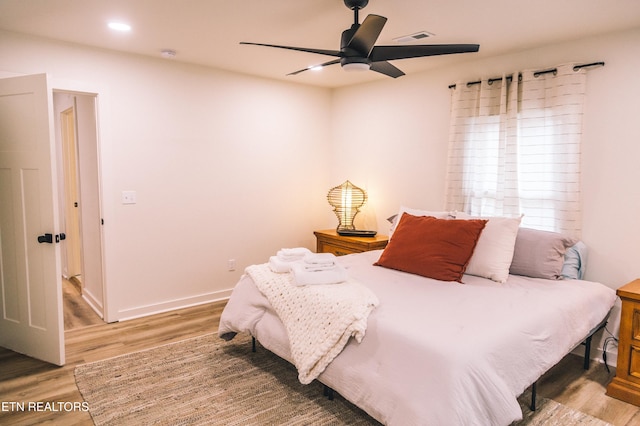 bedroom featuring ceiling fan and hardwood / wood-style flooring