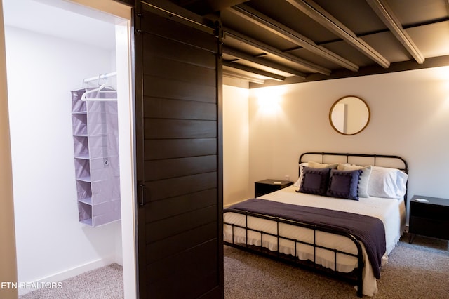 bedroom with beam ceiling and carpet floors