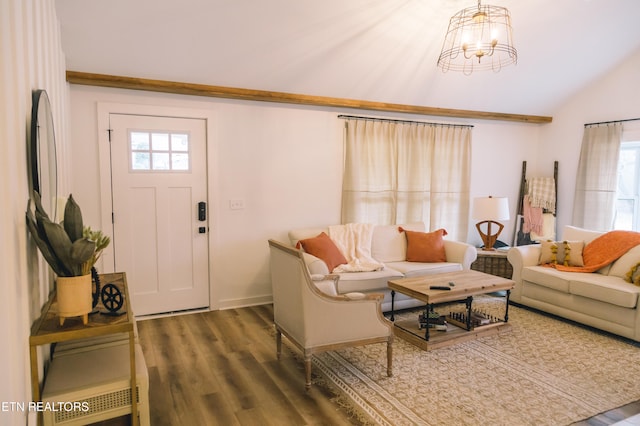 living room featuring lofted ceiling, a healthy amount of sunlight, dark hardwood / wood-style floors, and a notable chandelier