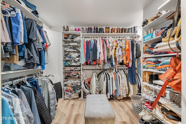 spacious closet with light hardwood / wood-style flooring