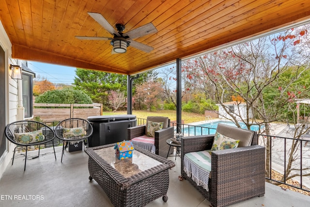 view of patio / terrace featuring ceiling fan and a swimming pool