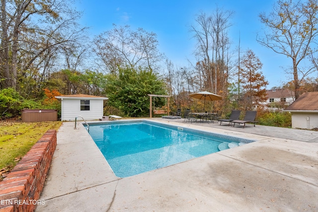 view of pool featuring an outdoor structure and a patio area