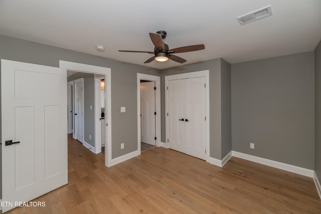 unfurnished bedroom with light wood-type flooring and ceiling fan