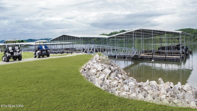 dock area with a yard and a water view