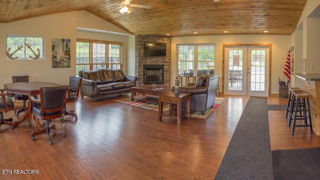 living room featuring dark hardwood / wood-style flooring, a fireplace, and wooden ceiling