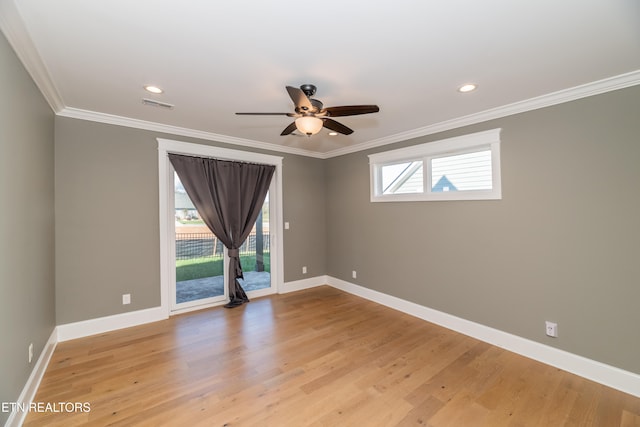 spare room featuring light hardwood / wood-style flooring, ceiling fan, and ornamental molding