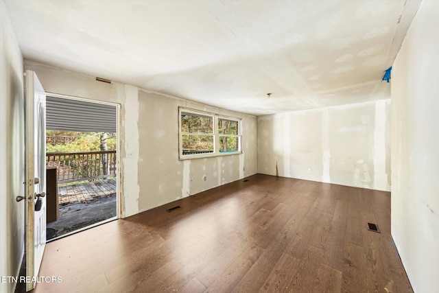 unfurnished room with hardwood / wood-style flooring