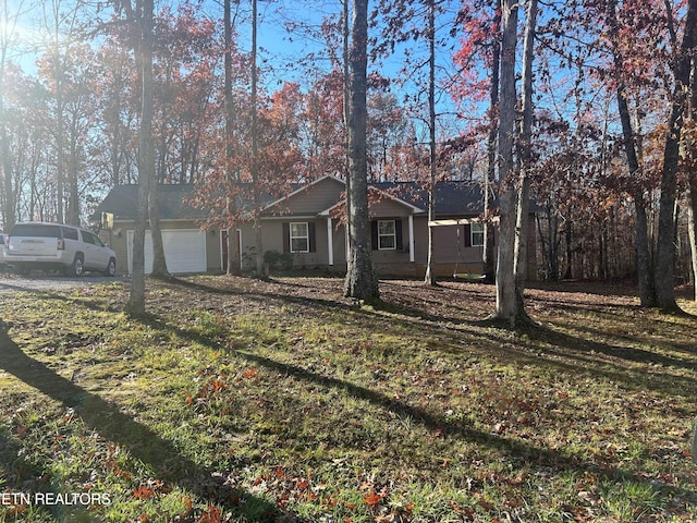 single story home with a garage and a front yard