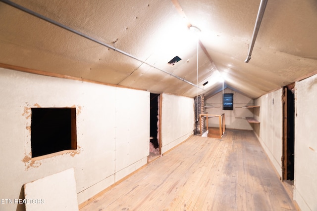 bonus room featuring hardwood / wood-style flooring and vaulted ceiling