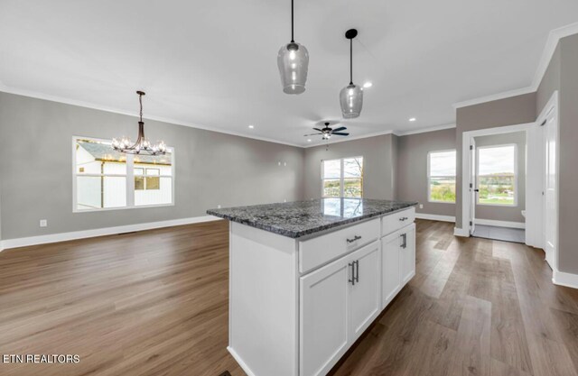250 Clear Creek Rd, Kodak, TN 37764 - kitchen featuring a center island, wood finished floors, baseboards, ornamental molding, and ceiling fan
